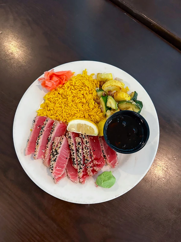 Dinner on a private island with sesame seared ahi tuna, house rice, vegetable du jour, wakame, pickled ginger, wasabi, mango salsa, and chipotle in Sarasota, FL