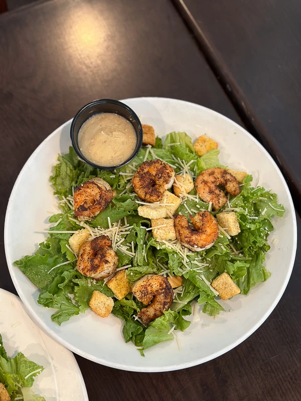Caesar Salad with romaine, parmesan, croutons, and grilled shrimp on a private island in Sarasota, FL